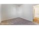 Neutral carpeted bedroom bathed in natural light, offering a cozy and inviting atmosphere at 123 Prestwick Way # 42, Mooresville, NC 28115