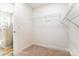 Walk-in closet featuring carpet flooring, access to a shower, and wire shelving at 123 Prestwick Way # 42, Mooresville, NC 28115