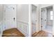 Elegant foyer with white wainscoting, hardwood floors, and access to multiple rooms at 123 Prestwick Way # 42, Mooresville, NC 28115