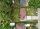 Aerial view showing the house with a large backyard, carport, and surrounding lush greenery at 1333 Washington Ln, Kannapolis, NC 28083