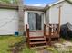 A wood deck at the back of a light gray house with sliding glass door and a large chimney at 1333 Washington Ln, Kannapolis, NC 28083