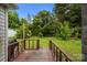 Back deck leading out to a sprawling, well-maintained green yard and mature trees at 1333 Washington Ln, Kannapolis, NC 28083