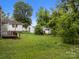 Large green backyard featuring an external shed, green grass and lush surrounding trees at 1333 Washington Ln, Kannapolis, NC 28083