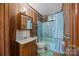 Bathroom features wood paneling, updated fixtures, and a blue bathtub at 1333 Washington Ln, Kannapolis, NC 28083