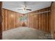 Bedroom with wood paneling, neutral carpet and corner windows at 1333 Washington Ln, Kannapolis, NC 28083