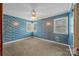 Bedroom with blue patterned wallpaper, neutral carpet and two windows at 1333 Washington Ln, Kannapolis, NC 28083