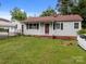 A well-maintained single-story home with a tidy front lawn and a cozy covered porch entry at 1333 Washington Ln, Kannapolis, NC 28083