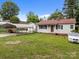 Lovely light gray home with a carport, white car, and an expansive green front lawn at 1333 Washington Ln, Kannapolis, NC 28083