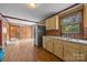 Kitchen with wood paneling, light yellow cabinets, and stainless steel refrigerator at 1333 Washington Ln, Kannapolis, NC 28083