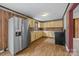 The kitchen features wood paneling, light yellow cabinets, and a stainless steel refrigerator at 1333 Washington Ln, Kannapolis, NC 28083