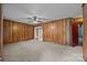 This cozy living room features wood paneling, ceiling fan, and an open layout perfect for entertaining at 1333 Washington Ln, Kannapolis, NC 28083