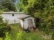 Backyard shed covered with vines and foliage, along with a wooden fence at 1333 Washington Ln, Kannapolis, NC 28083
