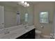 Bright bathroom featuring double sink vanity, large mirror, and combination shower tub at 137 Flora Vista Dr, Mooresville, NC 28117