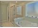 Bright bathroom with soaking tub, window, and separate glass enclosed shower at 137 Flora Vista Dr, Mooresville, NC 28117