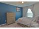 Bedroom with light gray walls, large dresser, and bright window with natural light at 137 Flora Vista Dr, Mooresville, NC 28117
