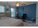 Bedroom with a blue accent wall, neutral furniture, and ceiling fan at 137 Flora Vista Dr, Mooresville, NC 28117
