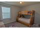 Bedroom with a wooden bunk bed, window, and neutral colors at 137 Flora Vista Dr, Mooresville, NC 28117