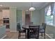 Cozy dining area adjacent to the kitchen with a staircase in the background at 137 Flora Vista Dr, Mooresville, NC 28117