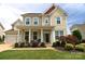 Charming two-story home with inviting front porch, manicured lawn, and attached garage in desirable neighborhood at 137 Flora Vista Dr, Mooresville, NC 28117