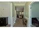 Hallway with hardwood floors leading to living room, with neutral paint and elegant trim at 137 Flora Vista Dr, Mooresville, NC 28117