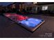 Enjoy a relaxing evening in this hot tub illuminated with colorful lights, set on a spacious wooden deck at 137 Flora Vista Dr, Mooresville, NC 28117