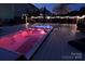 Enjoy a relaxing evening in this hot tub illuminated with colorful lights, set on a spacious wooden deck at 137 Flora Vista Dr, Mooresville, NC 28117