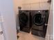 Laundry room featuring side by side washer and dryer units and storage shelves at 137 Flora Vista Dr, Mooresville, NC 28117