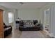 Cozy living room featuring hardwood floors, leather sofa, and a mini refrigerator for added convenience at 137 Flora Vista Dr, Mooresville, NC 28117