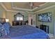Spacious main bedroom featuring trey ceiling, large mirror dresser, and TV at 137 Flora Vista Dr, Mooresville, NC 28117