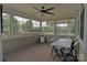 Relaxing sunroom with multiple windows offering views of a landscaped backyard at 137 Flora Vista Dr, Mooresville, NC 28117