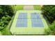 Aerial view of community tennis courts surrounded by lush greenery, perfect for active recreation at 137 Flora Vista Dr, Mooresville, NC 28117