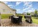 Outdoor patio with gas grill, outdoor dining set, and manicured landscaping at 14228 Twin Eagles Ln, Charlotte, NC 28278