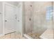 Modern bathroom featuring a glass-enclosed shower with stone flooring at 14228 Twin Eagles Ln, Charlotte, NC 28278