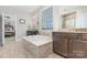 Bright bathroom with a built-in tub and dual vanities at 14228 Twin Eagles Ln, Charlotte, NC 28278