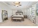 Elegant bedroom with a wooden bed frame, bench, and neutral color scheme at 14228 Twin Eagles Ln, Charlotte, NC 28278