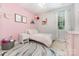 Cozy bedroom featuring a bright pink accent wall and stylish decor at 14228 Twin Eagles Ln, Charlotte, NC 28278