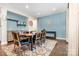 Bright dining room features hardwood floors, blue accent wall, and stylish decor at 14228 Twin Eagles Ln, Charlotte, NC 28278