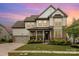 Charming two-story home with a landscaped yard and a welcoming front porch at 14228 Twin Eagles Ln, Charlotte, NC 28278