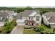 Charming two-story home boasts a manicured front yard, a cozy front porch, and a two-car garage at 14228 Twin Eagles Ln, Charlotte, NC 28278