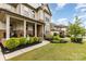 Inviting covered front porch with stone accents and a well-maintained lawn at 14228 Twin Eagles Ln, Charlotte, NC 28278