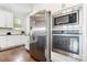 Stainless steel appliances, granite countertop and modern white cabinets in kitchen at 14228 Twin Eagles Ln, Charlotte, NC 28278
