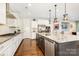 The chef's kitchen showcases granite countertops, stainless appliances and a modern style at 14228 Twin Eagles Ln, Charlotte, NC 28278