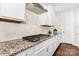 Gourmet kitchen with gas cooktop, granite countertops, and white cabinets at 14228 Twin Eagles Ln, Charlotte, NC 28278