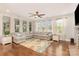 Bright living room with large windows, a sectional sofa, and hardwood flooring at 14228 Twin Eagles Ln, Charlotte, NC 28278