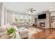 Comfortable living room with stone fireplace, hardwood floors, and a large sectional sofa at 14228 Twin Eagles Ln, Charlotte, NC 28278