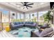 Inviting screened porch with comfortable blue sectional seating and ceiling fan at 14228 Twin Eagles Ln, Charlotte, NC 28278