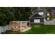 Home's backyard showcasing an outdoor patio under a pergola, seating, and manicured lawn, ideal for entertaining at 1446 Downs Ave, Charlotte, NC 28205