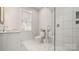 Bright bathroom features a glass shower, white tile, and a marble-topped vanity at 1446 Downs Ave, Charlotte, NC 28205