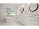 Bright bathroom features a standalone tub, dual sinks, and a window at 1446 Downs Ave, Charlotte, NC 28205