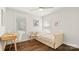 Cozy bedroom with hardwood floors, a daybed, a desk, and bright windows offering natural light at 1446 Downs Ave, Charlotte, NC 28205